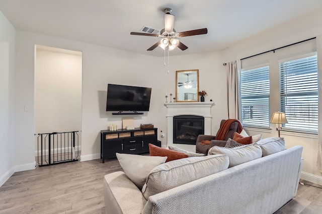 living room featuring ceiling fan and light hardwood / wood-style flooring