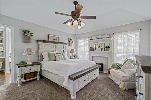 carpeted bedroom with ceiling fan and lofted ceiling