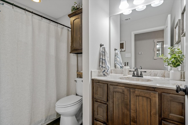 bathroom featuring toilet and vanity