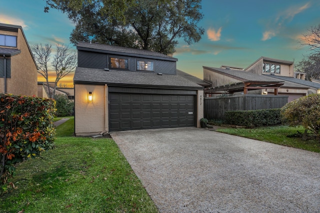 view of front facade with a garage and a lawn