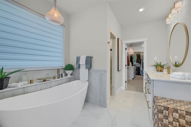 bathroom with a tub to relax in and vanity