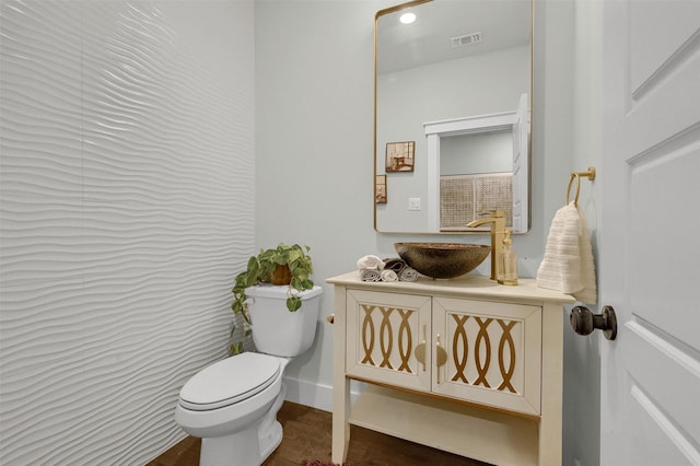 bathroom featuring toilet and vanity