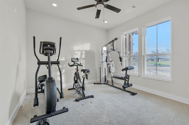 workout room with light carpet and ceiling fan