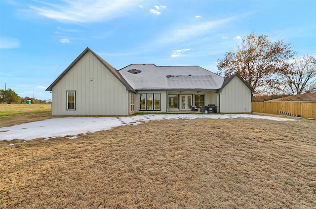 rear view of property with a lawn