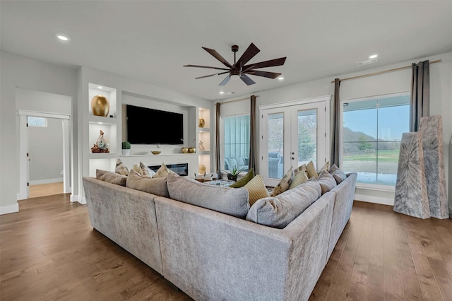 living room featuring hardwood / wood-style flooring, french doors, and ceiling fan