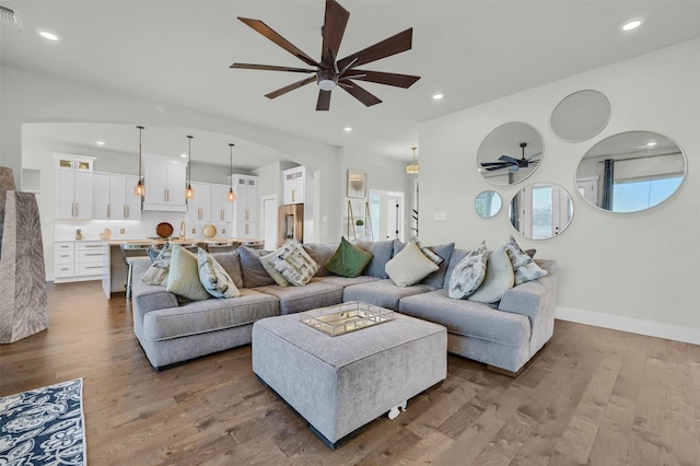 living room featuring ceiling fan and hardwood / wood-style floors