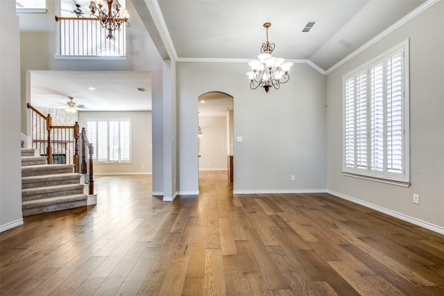 spare room featuring hardwood / wood-style flooring, a wealth of natural light, crown molding, and vaulted ceiling