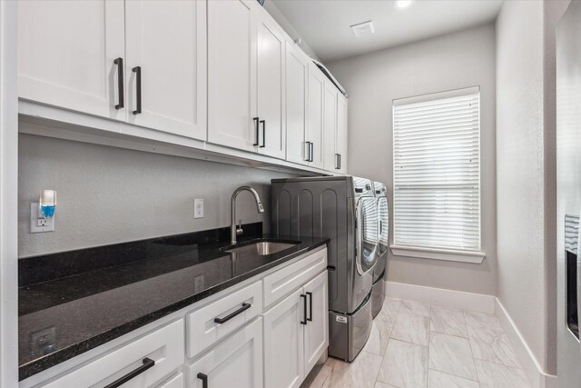 kitchen with premium range hood, hanging light fixtures, appliances with stainless steel finishes, a kitchen island with sink, and white cabinets