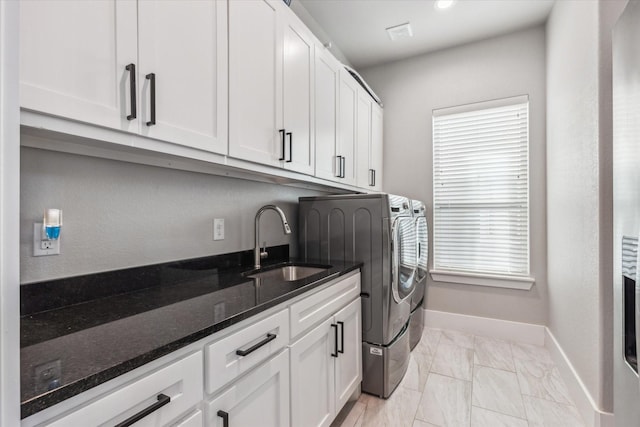 laundry area with separate washer and dryer, marble finish floor, a sink, baseboards, and cabinet space