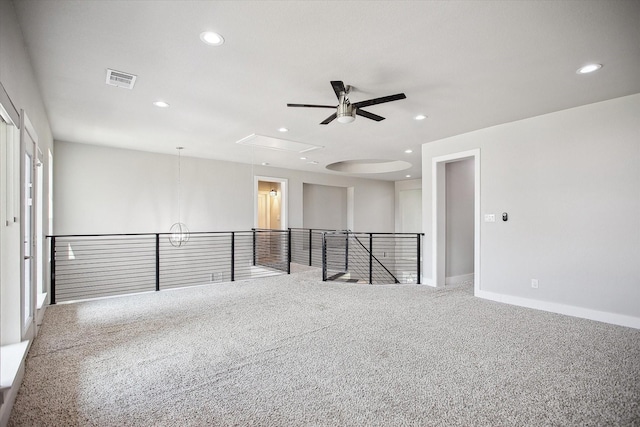 empty room featuring recessed lighting, attic access, visible vents, ceiling fan, and carpet