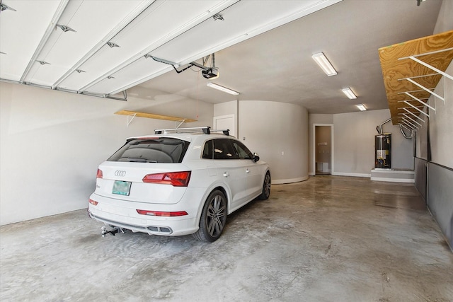 garage featuring a garage door opener and water heater