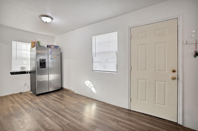 kitchen featuring dark wood-type flooring and stainless steel fridge with ice dispenser