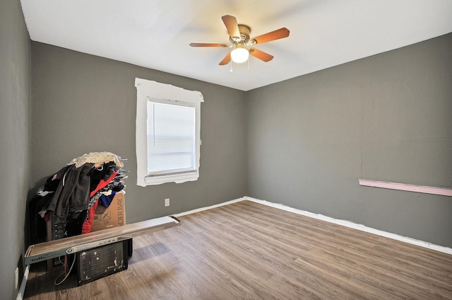 unfurnished room with ceiling fan and hardwood / wood-style floors