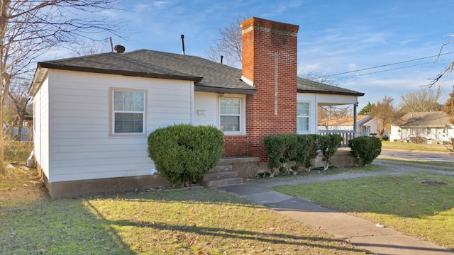 bungalow-style home featuring a front yard