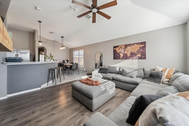 living room with hardwood / wood-style flooring, high vaulted ceiling, and ceiling fan