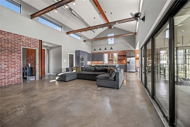 living room featuring high vaulted ceiling, brick wall, beam ceiling, and concrete flooring