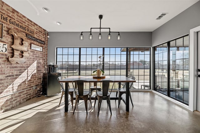 dining area featuring brick wall