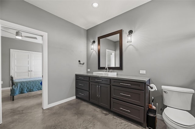 bathroom featuring toilet, vanity, and concrete flooring