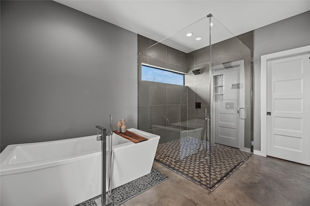 bathroom with plus walk in shower and concrete flooring