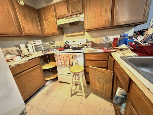 kitchen with light tile patterned floors and white electric range