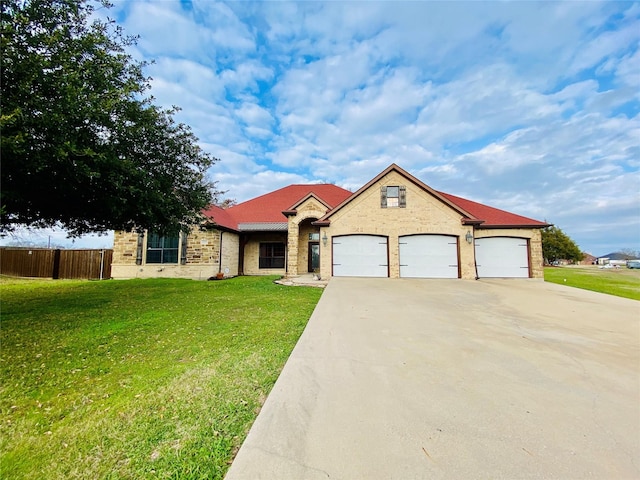 view of front of house with a garage and a front lawn