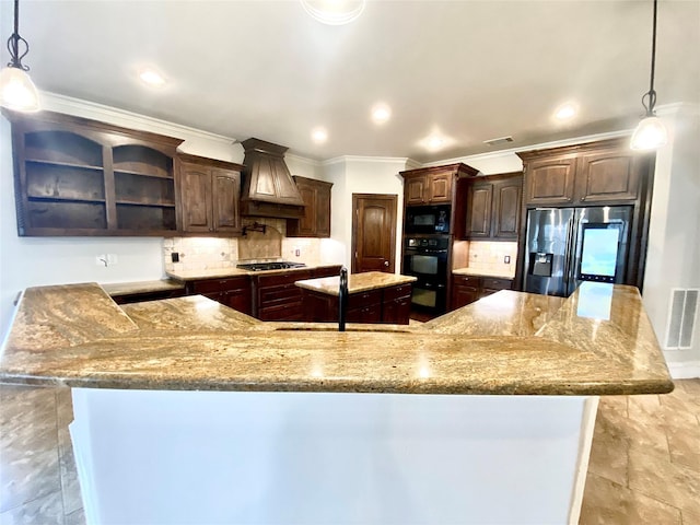 kitchen featuring decorative light fixtures, dark brown cabinets, black appliances, and premium range hood