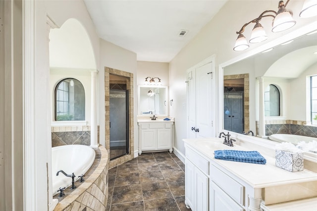 10545 Lago Vis, Quinlan, TX 75474 - full bathroom with a shower stall, two vanities, a bath, and stone finish floors