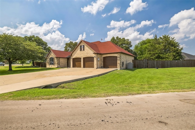 10545 Lago Vis, Quinlan, TX 75474 - french country inspired facade with concrete driveway, brick siding, an attached garage, and central air condition unit