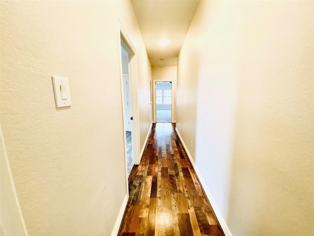 hallway with dark hardwood / wood-style flooring