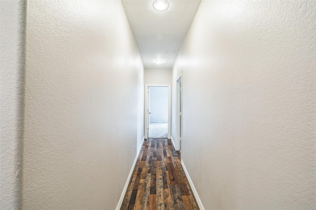 10545 Lago Vis, Quinlan, TX 75474 - hall with dark wood-style flooring, baseboards, and a textured wall