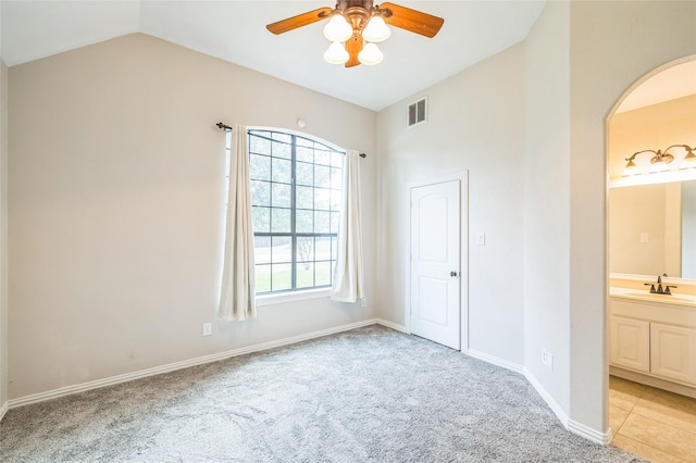10545 Lago Vis, Quinlan, TX 75474 - unfurnished bedroom featuring arched walkways, a sink, lofted ceiling, light carpet, and connected bathroom