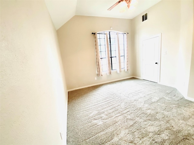 unfurnished room with vaulted ceiling, carpet, and ceiling fan