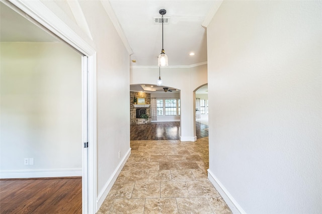 10545 Lago Vis, Quinlan, TX 75474 - corridor featuring crown molding, arched walkways, baseboards, and light stone finish floors