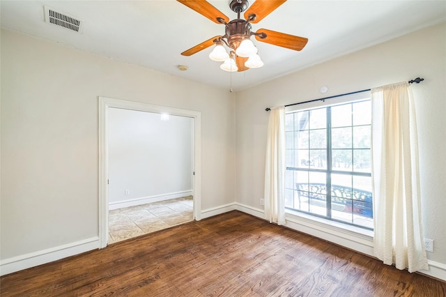 10545 Lago Vis, Quinlan, TX 75474 - empty room with wood finished floors, a ceiling fan, and baseboards