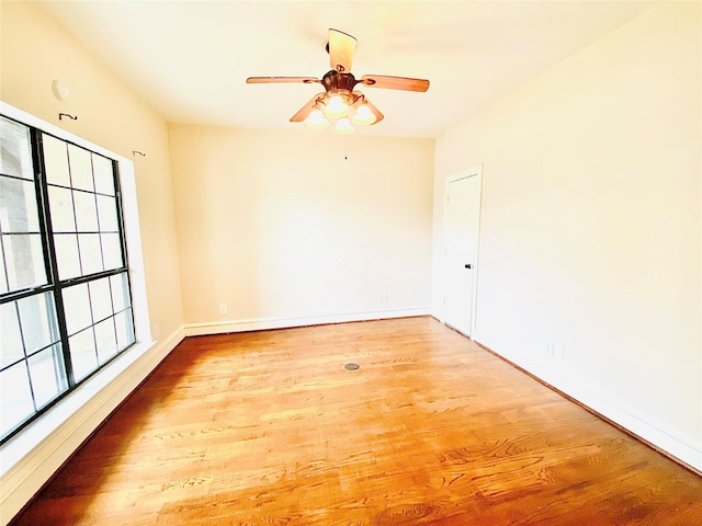 unfurnished room with hardwood / wood-style floors and ceiling fan