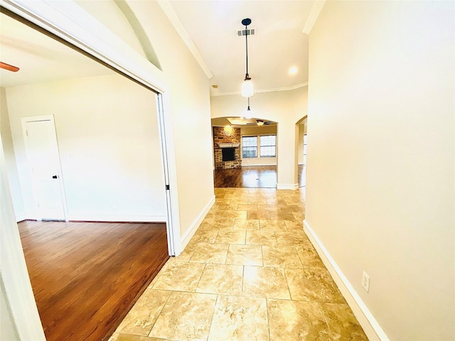 corridor featuring crown molding