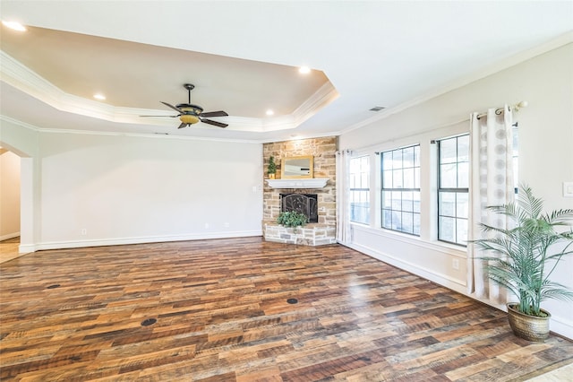 10545 Lago Vis, Quinlan, TX 75474 - unfurnished living room featuring wood finished floors, a tray ceiling, crown molding, a ceiling fan, and arched walkways