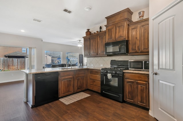 kitchen featuring black appliances, sink, kitchen peninsula, dark hardwood / wood-style flooring, and backsplash