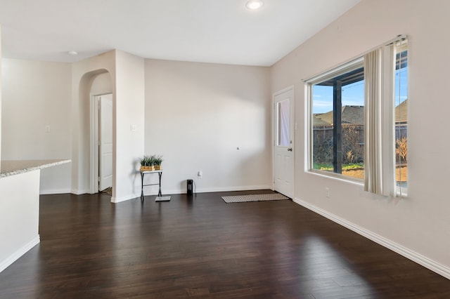 empty room with dark hardwood / wood-style floors