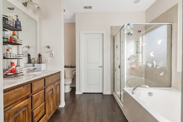 full bathroom featuring vanity, toilet, plus walk in shower, and hardwood / wood-style flooring