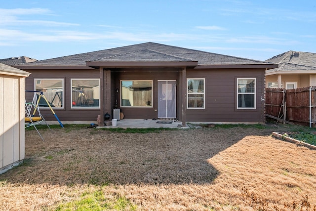 rear view of house featuring a lawn