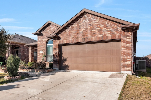 front of property with cooling unit and a garage