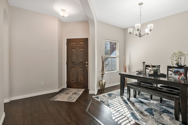 foyer entrance featuring dark hardwood / wood-style floors and a notable chandelier