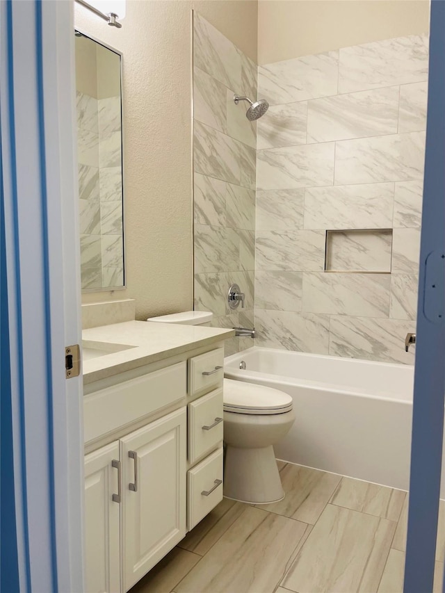 bathroom featuring washtub / shower combination, toilet, and vanity