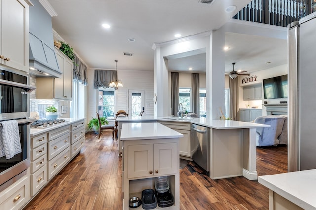 kitchen featuring white cabinets, appliances with stainless steel finishes, a center island, dark hardwood / wood-style flooring, and backsplash