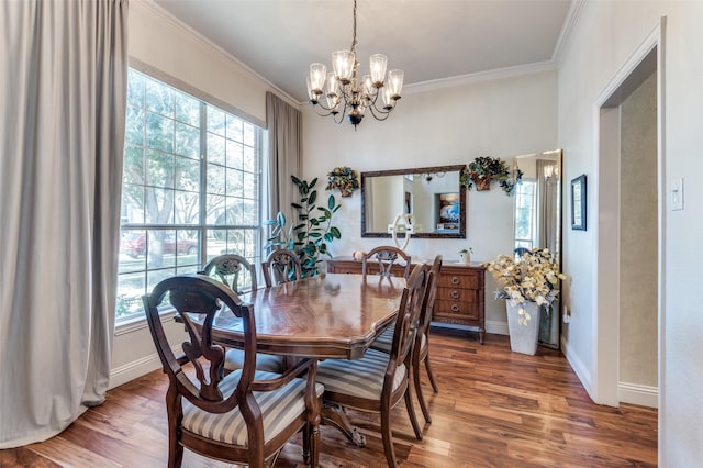 dining room featuring hardwood / wood-style floors, ornamental molding, and a notable chandelier