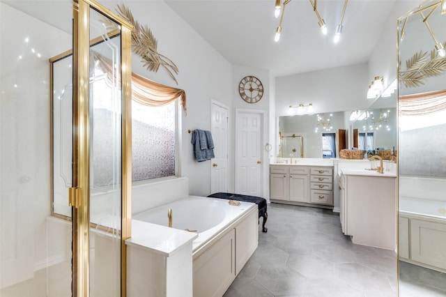 bathroom with independent shower and bath, an inviting chandelier, tile patterned floors, and vanity