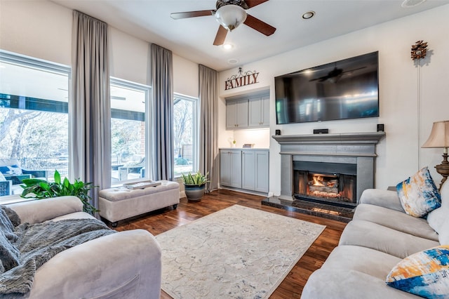 living room with dark hardwood / wood-style floors and ceiling fan