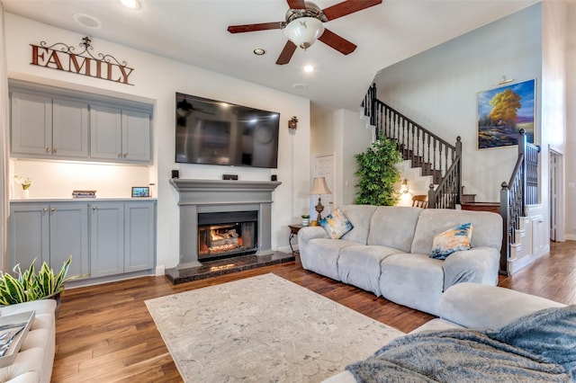 living room with wood-type flooring and ceiling fan