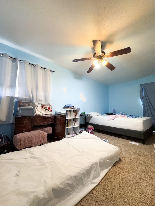 bedroom with ceiling fan and carpet